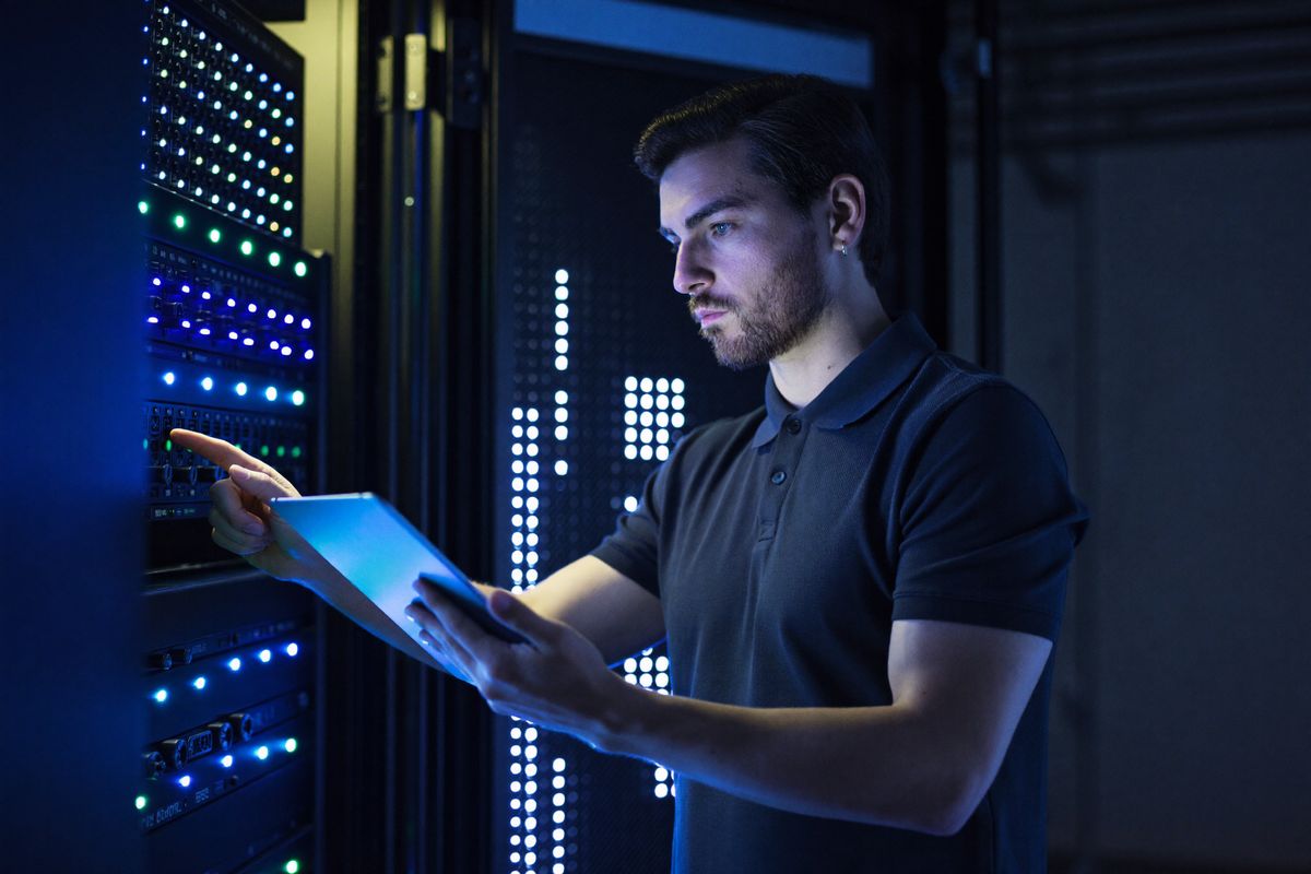 A BeHost technician inspecting a server rack