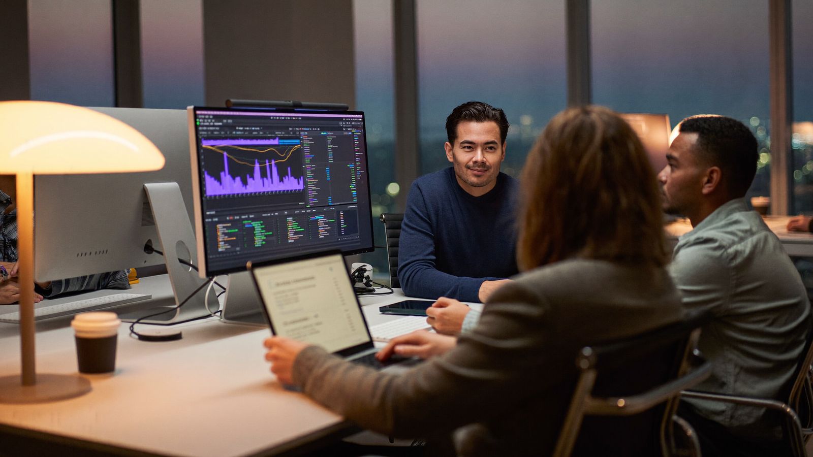 BeHost engineers reviewing server dashboards together at dusk
